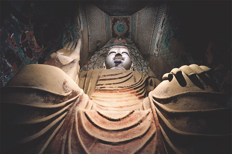 Buddhist cave figure representing the cultural source behind Dunhuang-inspired spiritual jewelry