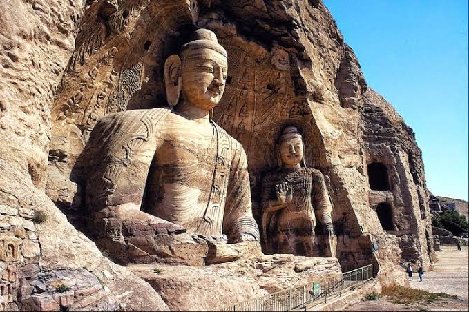 Rock-cut Buddhist cave landscape representing the grotto tradition near Dunhuang