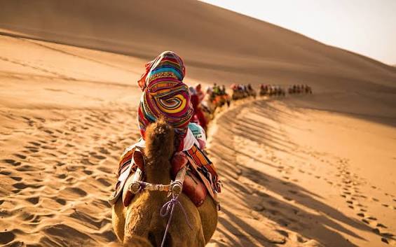 A caravan crossing the desert landscape associated with Dunhuang